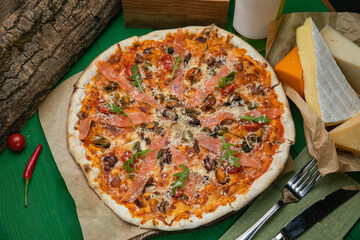 Pizza with cheese and salmon in an Italian pizzeria
