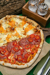 pizza with sausage, cheese, tomatoes and herbs
