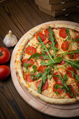 pizza with sausage, cheese, tomatoes and herbs
