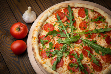 Pizza with cheese, herbs and meat in an Italian pizzeria
