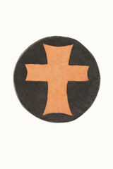 Obraz premium Tan leather medallion cross on a circular rawhide background isolated. The cross is handmade in two tones of leather and the cross symbolizes Christ in the world.