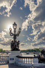 Fototapeta na wymiar Paris, France - May 23, 2020: Famous street lantern on the Alexandre III Bridge in Paris