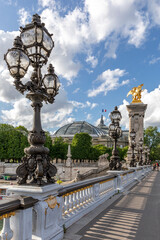 Fototapeta na wymiar Paris, France - May 23, 2020: Famous street lantern on the Alexandre III Bridge in Paris