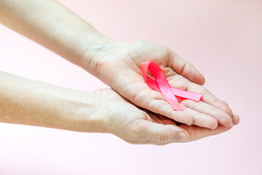 October Breast Cancer Awareness Month, Adult Woman Hand Holding Pink Ribbon