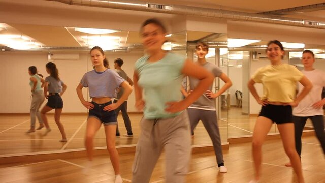 Group of teenage boys and girls enjoying dance class together