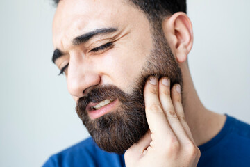 Dental health and care concept. Attractive man feeling painful toothache