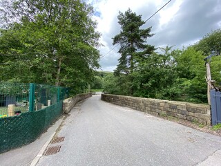View down, Horest Lane, with old trees, and stone walls, on a cloudy day in, Delph, Oldham, UK