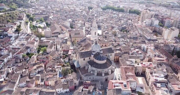 View from drone of Roman Catholic Basilica in Spanish town of Xativa on background of residential areas 