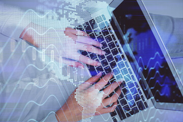 Double exposure of woman hands working on computer and forex chart hologram drawing. Top View. Financial analysis concept.