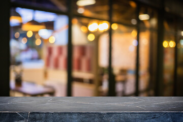 Empty black marble stone table top and blur glass window interior restaurant and cafe banner mock up background - can used for display or montage your products.