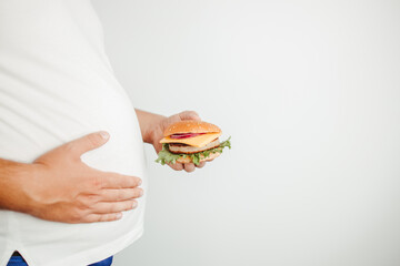 Glutton man eating tasty burger. Fast food