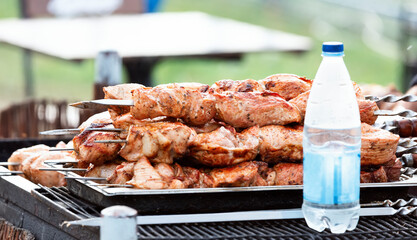 Marinated shashlik is cooked on a charcoal grill. Ready kebab on skewers