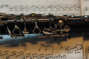 Obraz premium part of a clarinet against sheet music