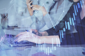 Multi exposure of woman hands typing on computer and financial graph hologram drawing. Stock market analysis concept.