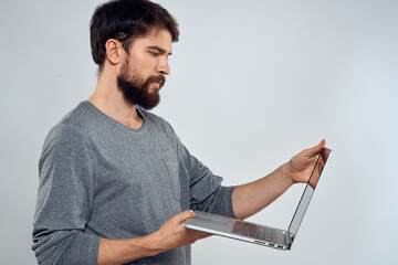 Emotional man holding a laptop success modern style work light background