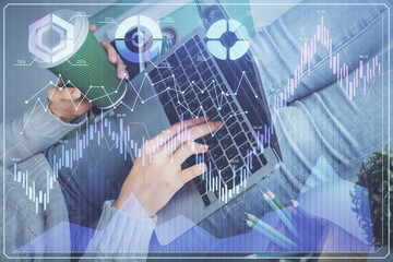 Double exposure of woman hands typing on computer and forex chart hologram drawing. Stock market invest concept.