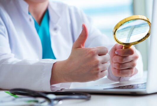 The doctor hand with magnifying glass