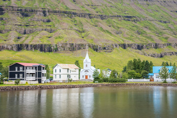 Fototapeta na wymiar Old buildings near the lake in town of Seydisfjordur in Iceland