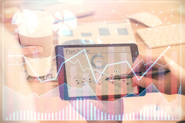 Double exposure of man's hands holding and using a phone and financial chart drawing. Market analysis concept.