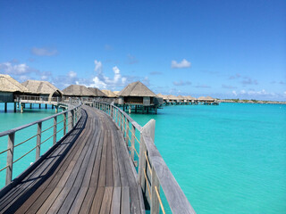 Walking on Pier Leading to Island Bungalows