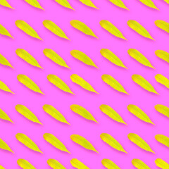 Seamless pattern. Yellow-green leaves isolated on a pink background