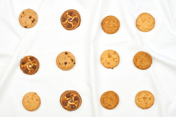 Sweet cookies on the pure white fabric blanket