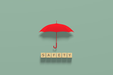 Opened red umbrella with wooden cubes wiht word safety