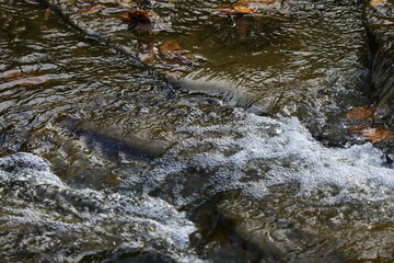 Flowing water over river rocks 