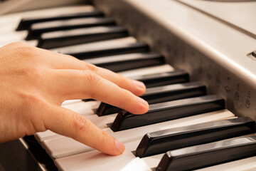 Fototapeta na wymiar hands of a child playing piano