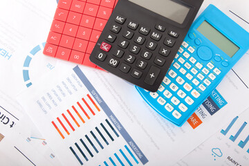 Three different color calculators on financial document background