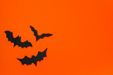 Halloween concept. Festive decorations. Bats on orange background.
