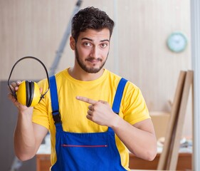 The young repairman carpenter working cutting wood