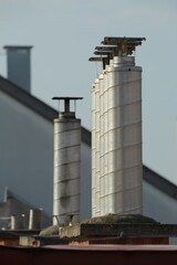 Chimneys on roofs in late afternoon light