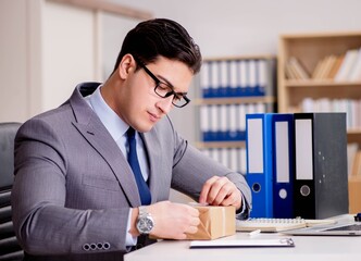 Businessman receiving parcel in office