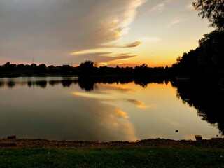 Sunset reflections in the lake with silhouettes of the trees