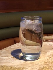 Medium close up of a clear glass of water on top of a table