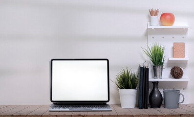 Mockup blank screen tablet with keyboard on wooden table. Copy space.