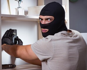 Burglar wearing balaclava mask at crime scene