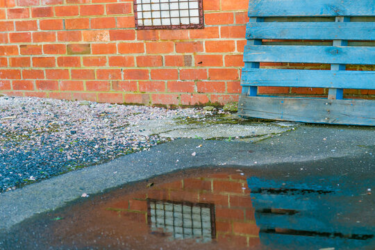 Urban alley with reflections in a puddle of water
