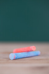Two colored chalks for teaching are on the table