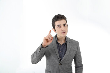 Middle eastern Caucasian young office business man wearing suit point finger up thinking planning on white studio background