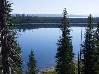 Breathtaking view of Yellowstone Lake frame by pine trees. Yellowstone National Park, Wyoming.