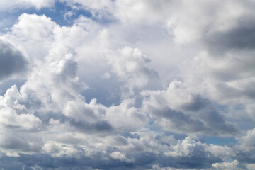 Fototapeta na wymiar Beautiful white cumulus clouds in the blue sky. Small gaps in the blue sky