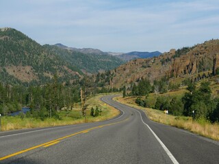 Breathtaking scenery and winding road at North Fork Highway, with the North Fork Soshone River on the way to Yellowstone National Park east entrance.