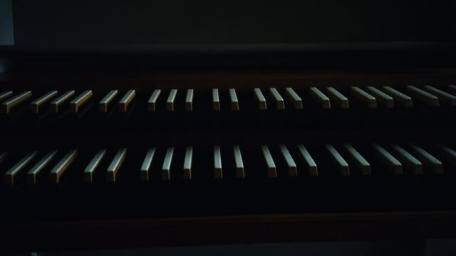 Close up sliding view of an old vintage pipe organ piano. Low key.