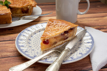 Traditional homemade apple pie with cranberries. Individual portion of the cake on a plate with...