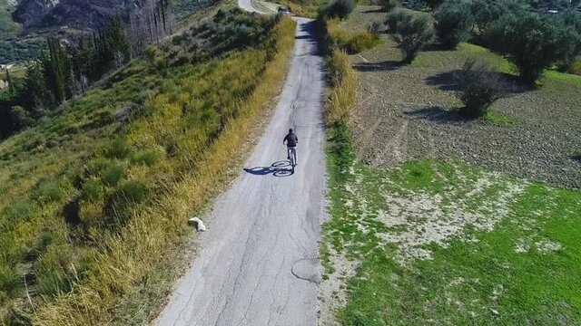 Aerial view of drone following Cube Bicycle rider on Mountain road