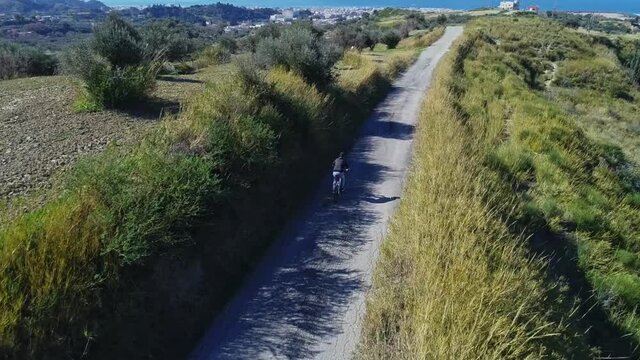 Aerial view of drone following Cube Bicycle rider on Mountain road