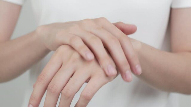 Close up of woman hand holding and applying moisturiser, Body lotion, isolated on white background.