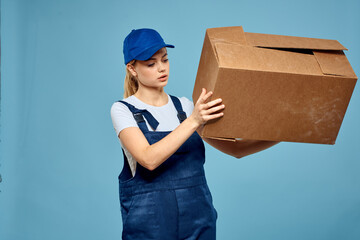 Woman working form box in hands packing delivery service blue background